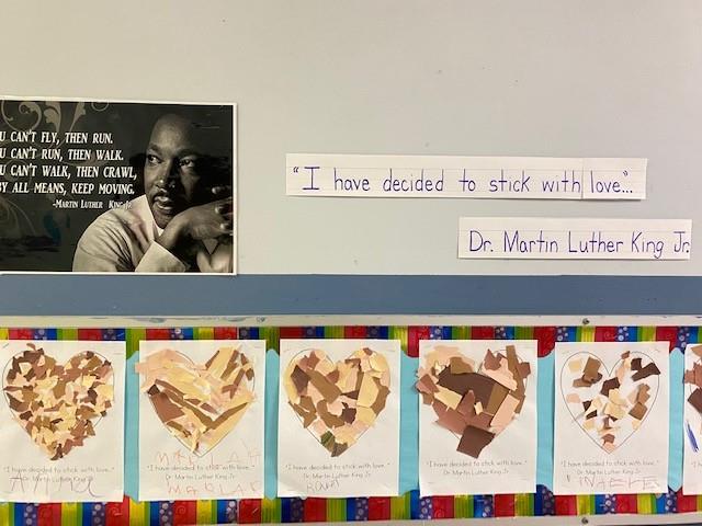 Photo shows several pieces of student-created art made of torn paper of different brown tones made into the shape of hearts.